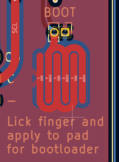 The exposed pads of the bootloader pins