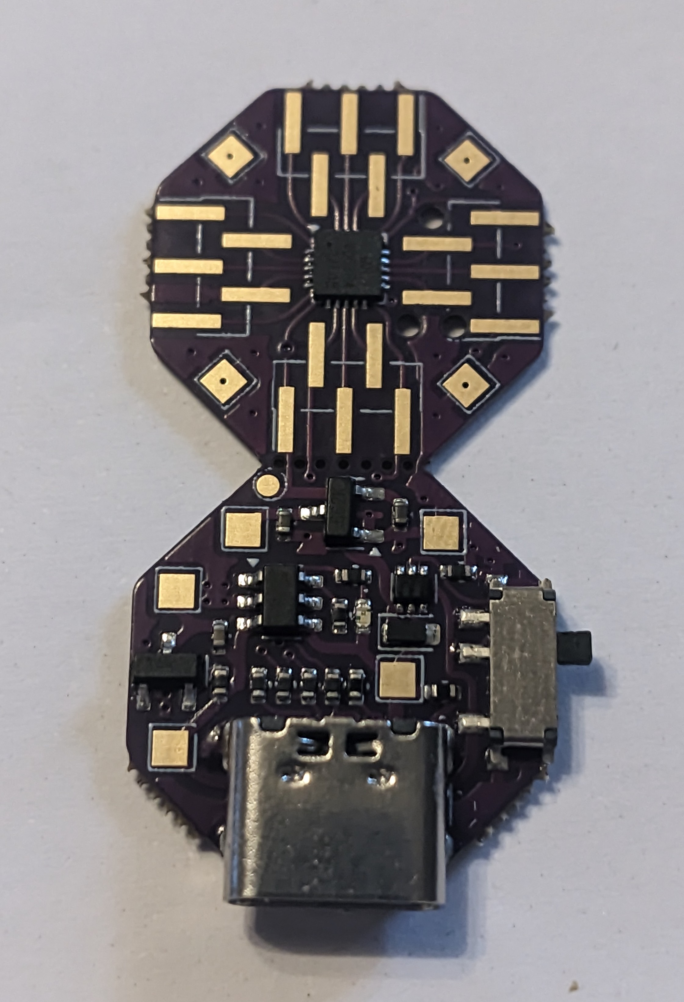 A purple circuit board shaped like two octagons connected on an edge